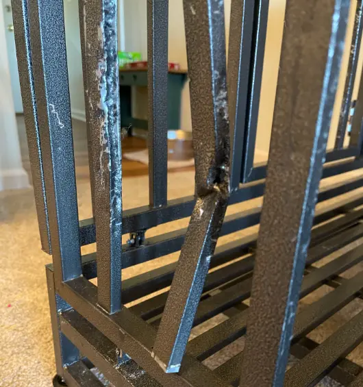 The dog chewed the bars of the metal crate